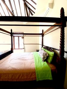 a bedroom with a bed with a wooden frame at Imogen Yogyakarta in Yogyakarta