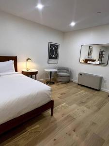 a bedroom with a bed and a table and a mirror at King Bed, Historic Hotel, Bangor, Room # 101 in Bangor