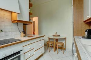 a kitchen with a table and two stools in it at LE Saint Martin in Versailles +3 photos