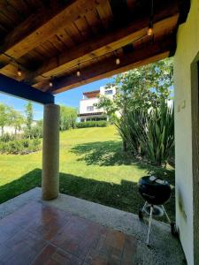 a patio with a grill and a grass yard at Ideal home for your next get away in San Miguel de Allende