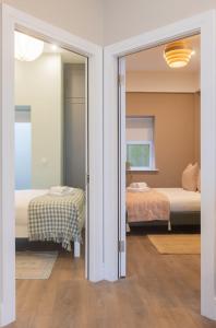 a room with two beds and a sliding glass door at GuestReady - Dublin 8 Delight Retreat in Dublin