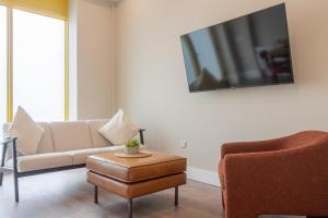 a living room with a couch and a tv on the wall at GuestReady - Dublin 8 Delight Retreat in Dublin
