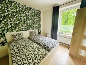 a bedroom with a bed and a wall with a window at Apartmány LUXOR in Česká Lípa +107 photos