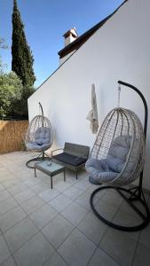 two swing chairs and a bench on a patio at Forr Apartments - Hvar, Croatia in Hvar +33 photos