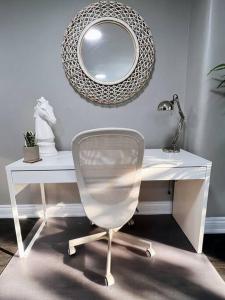 a white desk with a chair and a mirror at Elegant City Living - 1 BR in London