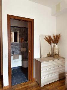 a bathroom with a sink and a toilet and a mirror at Apartment in town centre and nearby the lake in Riva del Garda
