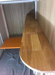 a wooden table in a room with a wooden floor at Comfy Stay in Da Nang