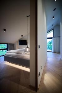 ein Schlafzimmer mit einem Bett und einem großen Fenster in der Unterkunft Gerl Homes - adults only apartments in Wals