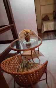 a glass table and a chair with a bowl on it at Casa na praia em frente as Dunas in Salvador