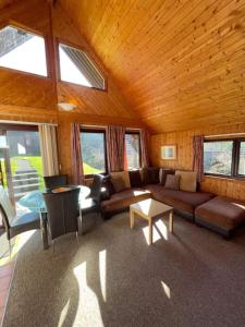 a living room with a couch and a table at 3 Bedroom Lodge Lanteglos 17 in Lanteglos