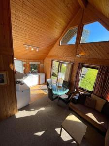 a living room with a glass table in a cabin at 3 Bedroom Lodge Lanteglos 17 in Lanteglos
