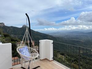 a chair on a balcony with a view at Attico BELLAVISTA in Baunei