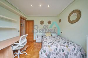 1 dormitorio con cama y escritorio en Ático Salesas, en Oviedo