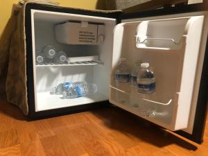 an open refrigerator with bottles of water in it at Studio with private bath room in Chicago