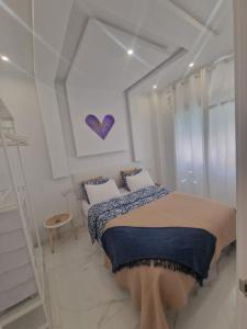 a white bedroom with a bed with two pillows at Casa estilo Riad Fez en Lo Pagan in San Pedro del Pinatar