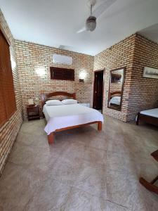 מיטה או מיטות בחדר ב-Pousada Solar das Fontes
