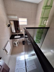 Baño con escalera con espejo y aseo en Pousada Solar das Fontes, en Beberibe