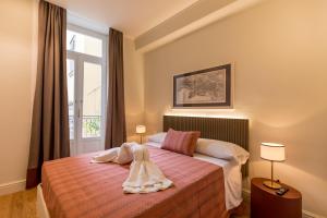 a bedroom with a bed with towels on it at Piazza San Domenico Luxury Suites in Naples