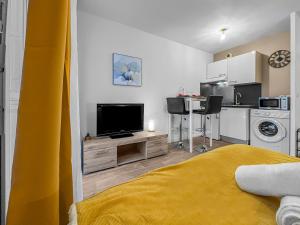 a living room with a bed and a kitchen at Studio enchanté avec terrasse in Luce