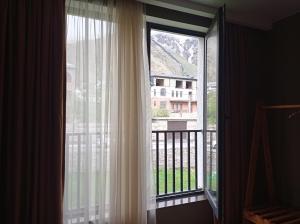 a window with a view of a balcony at Kazbegi 4U in Stepantsminda