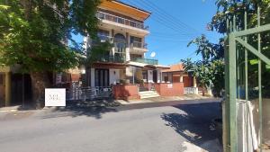 a building with a sale sign on the side of a street at Maryland Lodge kakopetria in Kakopetria