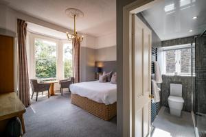 a hotel room with a bed and a bathroom at Ambleside Townhouse in Ambleside