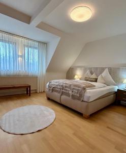 a bedroom with a large bed and a large window at Ferienwohnungen an der Hufeland-Therme in Bad Pyrmont