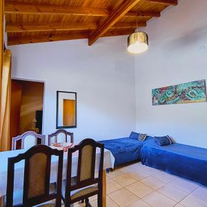 a room with a bed and a table and a couch at San Luis Aparts in Carpintería