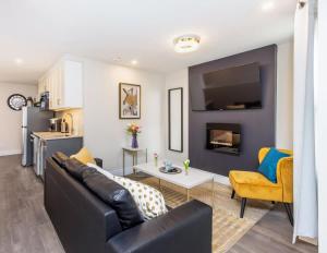 a living room with a couch and a table at Pet-Friendly 2BR Condo - Near University in Ottawa