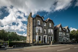 an old stone house on the side of a street at Ambleside Townhouse in Ambleside