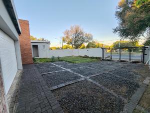 a driveway in front of a house with a gate at 2 Bedroom Private Retreat in Bloemfontein