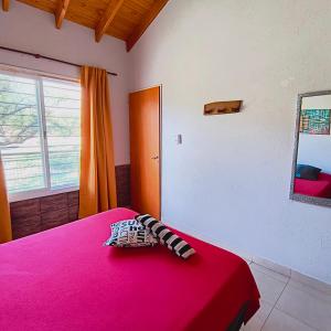 a room with a bed with a red blanket and a window at San Luis Aparts in Carpintería +74 photos
