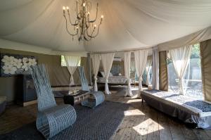 a large room with two beds and a chandelier at Glamping Canonici di San Marco in Mirano
