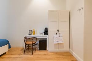 a small bedroom with a desk and a chair at Piazza San Domenico Luxury Suites in Naples