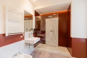 a bathroom with a sink and a shower at Piazza San Domenico Luxury Suites in Naples +82 photos