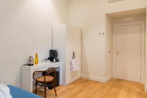 a bedroom with a desk and a bed and a table at Piazza San Domenico Luxury Suites in Naples