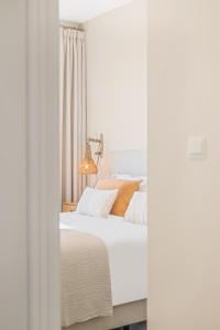 a bedroom with a white bed and a window at Seaflower Torrox Costa in Torrox Costa