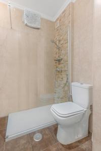 a bathroom with a white toilet and a shower at Seaflower Torrox Costa in Torrox Costa +30 photos
