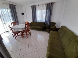 a living room with a couch and a table at Elezi House in Durrës