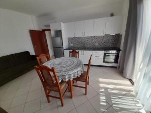 a kitchen with a table and chairs in a room at Elezi House in Durrës