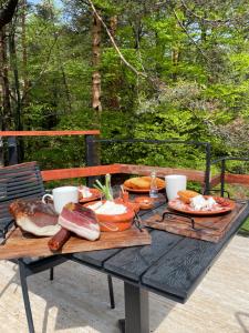 a picnic table with meat and other foods on it at Villa WOLF in Divčibare