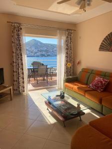 a living room with a couch and a table at Sea View Apartment in Sarandë +4 photos