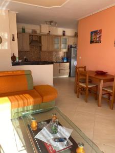 a living room and kitchen with a table and a couch at Sea View Apartment in Sarandë