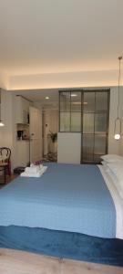 a large blue bed in a room with a kitchen at MUSES LUXURY SUITES in Corfu