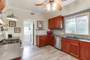 a kitchen with wooden cabinets and a ceiling fan at Harrison Family Home with Grill - Near Downtown! in Harrison