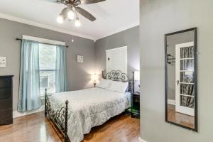a bedroom with a bed and a mirror at Harrison Family Home with Grill - Near Downtown! in Harrison
