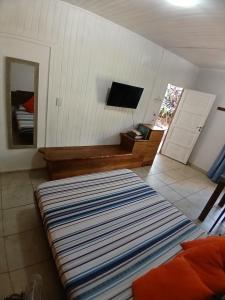 a living room with a bed and a television at Aloha hospedaje in Puerto Iguazú