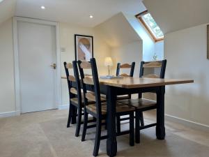 a dining room with a table and chairs at Garbity Cottage in Fochabers