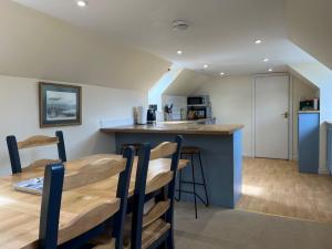 a kitchen and dining room with a table and chairs at Garbity Cottage in Fochabers