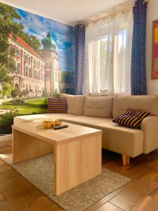 a living room with a couch and a coffee table at Apartament Centrum in Łańcut